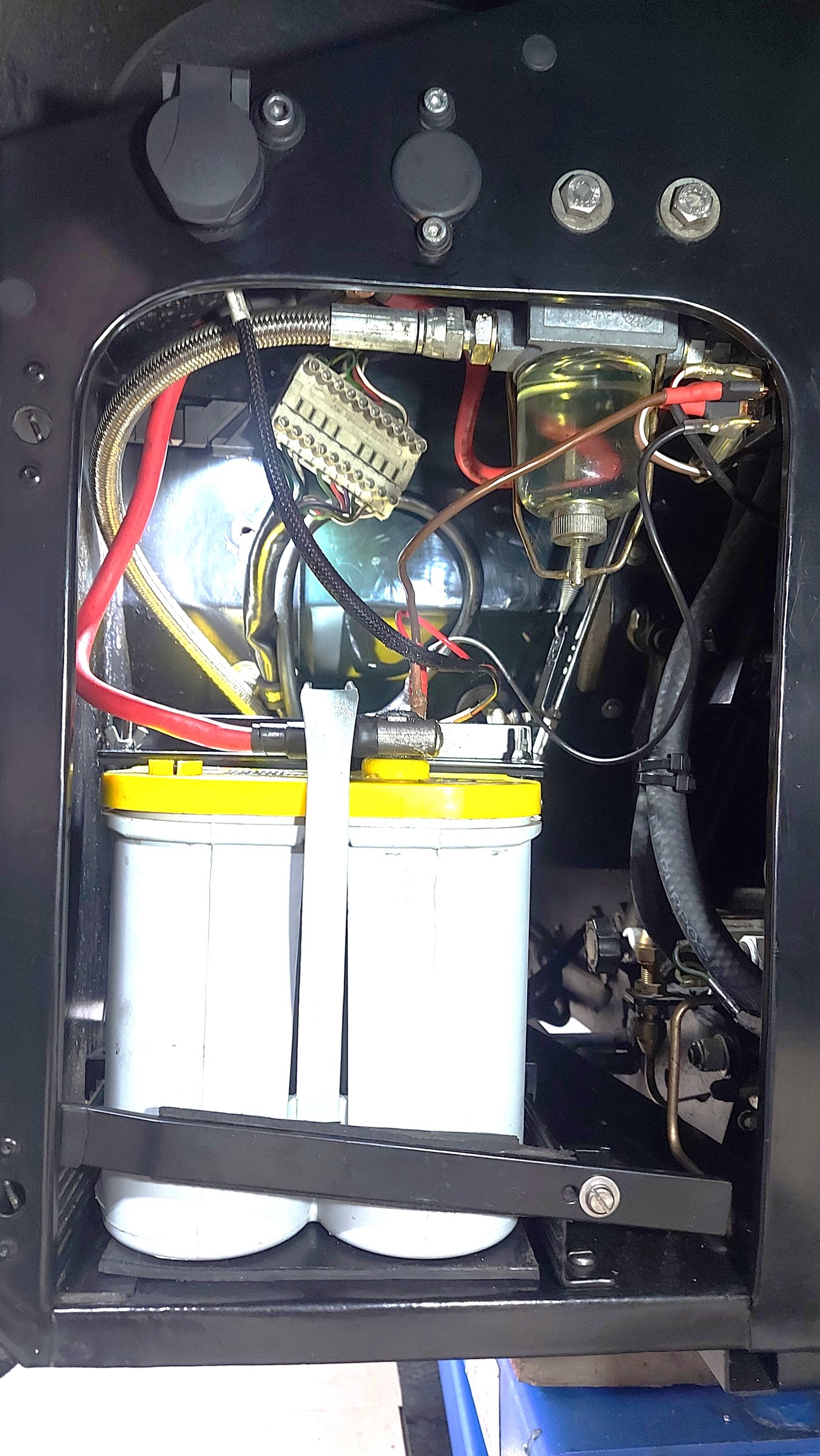 An under-wing battery box containing a battery, a glass-bowl fuel filter and wiring