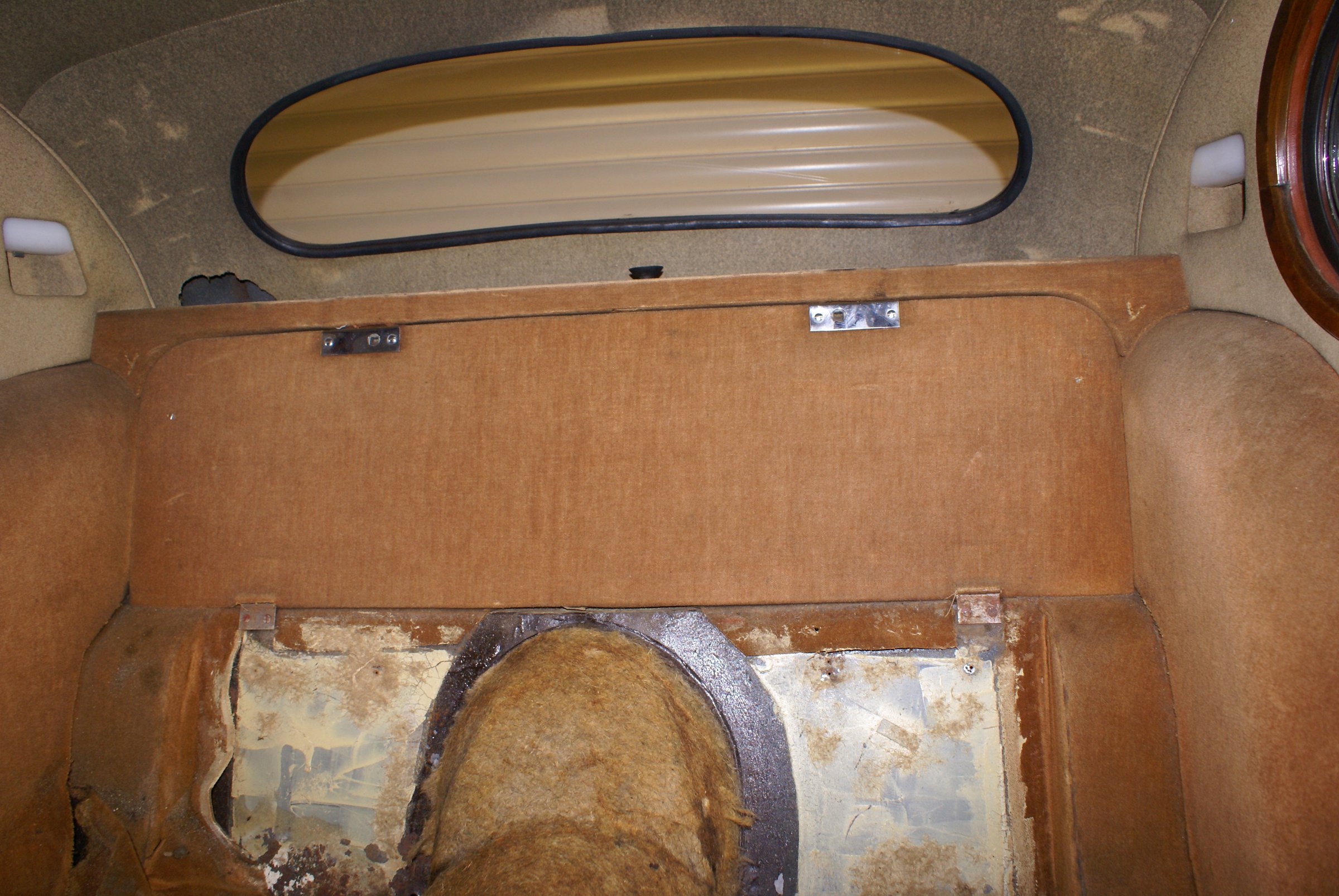 An XK140 interior stripped back to bare panels and padding